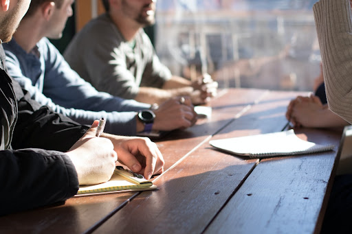 Team meeting where four employees are discussing the best practices for account planning